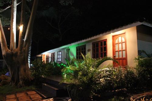 a house lit up at night with green lights at Red Moon Hideaway in Ko Chang