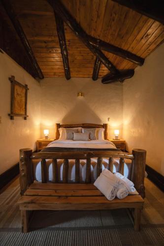 a bedroom with a bed with two towels on it at Hacienda Turistica Intihuatana in San Fernando