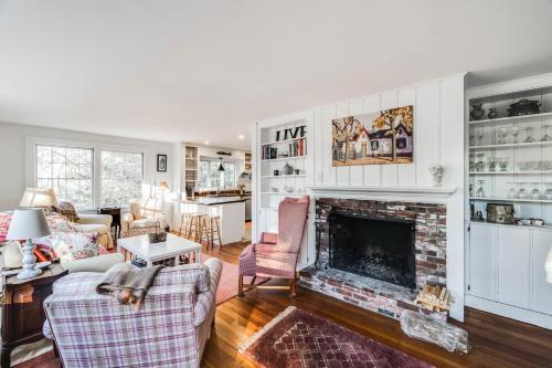 a living room with a fireplace and a couch at Sunny Days in Brewster