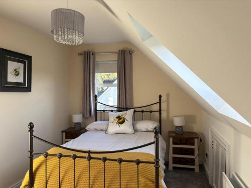 a bedroom with a bed with a yellow blanket at Shanawee in Gleneely