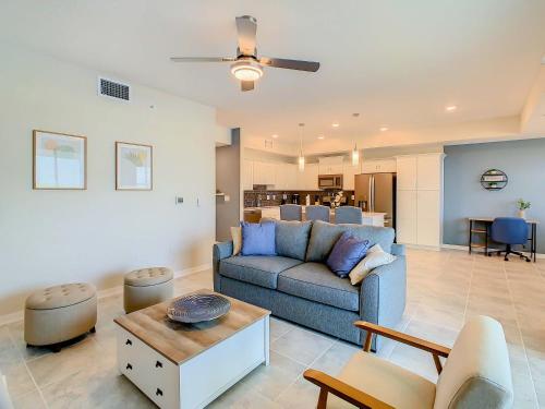 a living room with a blue couch and a table at Gorgeous 2BR lakeview Condo with Waterpark in Kissimmee