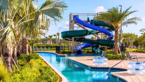 a water slide in a pool at a resort at Gorgeous 2BR lakeview Condo with Waterpark in Kissimmee