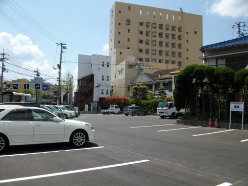 a white car is parked in a parking lot at Kokusai Hotel Yamaguchi in Yamaguchi