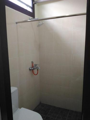 a bathroom with a toilet and a shower at K15 Exclusive in Malang