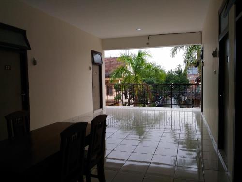 a room with a table and chairs and a balcony at K15 Exclusive in Malang