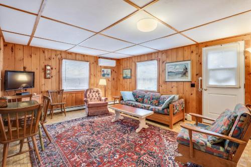 a living room with a couch and a table at Anchors Aweigh in Brewster