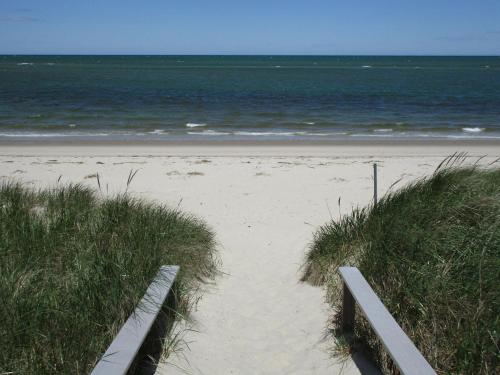 a path to the beach with the ocean in the background at Anchors Aweigh in Brewster
