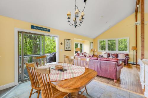 a living room with a table and a couch at Pleasant Point in Wellfleet