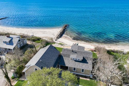 an aerial view of a house and the beach at Sea Winds in Brewster