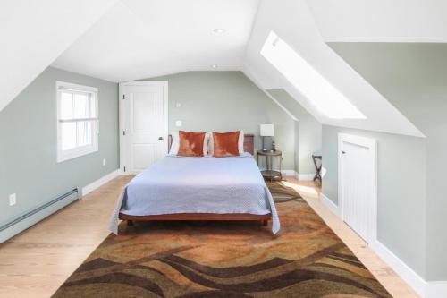 a bedroom with a bed and a rug at Harbor Hideaway in Provincetown