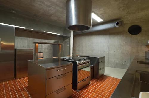 a kitchen with a stove top oven in a kitchen at Casa Piedra Villa in Cancún
