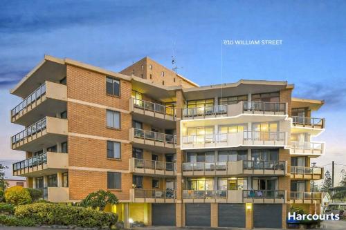 a tall brick building with balconies on it at Beachside Bliss in Port Macquarie