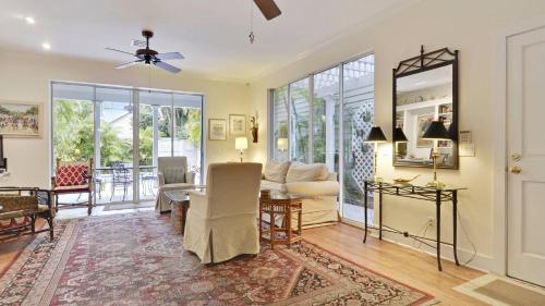 a living room with a table and a dining room at Amelia Home by AvantStay In Historic Old Town w Pool in Key West