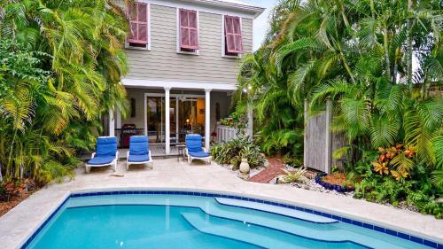 a house with a swimming pool in front of a house at Amelia Home by AvantStay In Historic Old Town w Pool in Key West