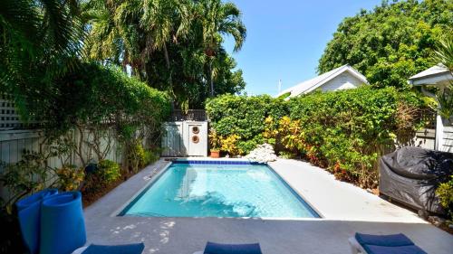 a small swimming pool in a yard with trees at Tropical Dreaming by AvantStay 4 BLKS to Beach Private Pool in Key West