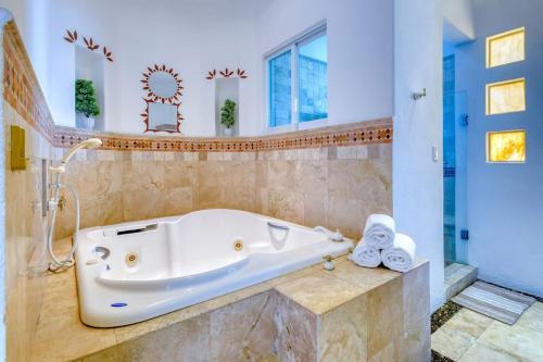 a bath tub in a bathroom with a shower at The Fairway Villa in San José del Cabo