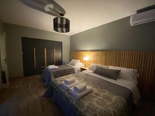 a bedroom with two beds with towels on them at H Molle in Cafayate