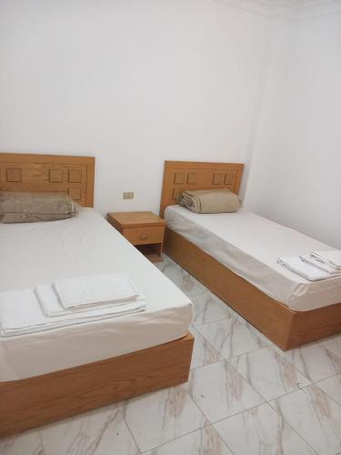 two beds sitting next to each other in a room at Sea simple haven in Sharm El Sheikh