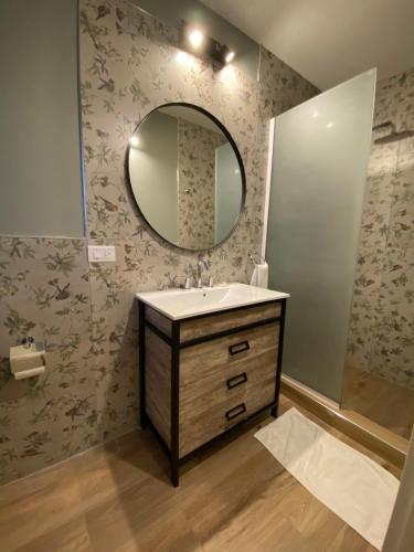 a bathroom with a sink and a mirror at H Molle in Cafayate