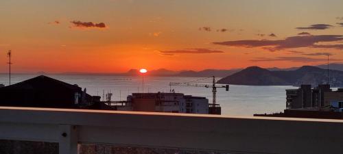 a sunset over a body of water with mountains at VISTAMAR 33 in Benidorm