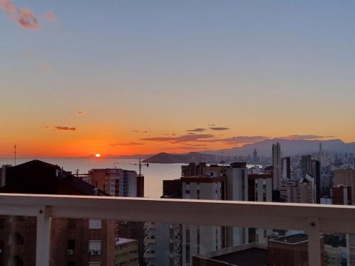 a view of a city at sunset from a balcony at VISTAMAR 33 in Benidorm
