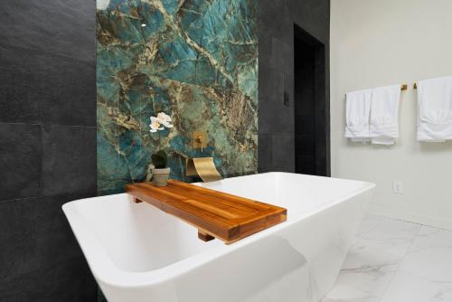 a bathroom with a tub with a wooden board on it at 4 Bed sleeps 12 -Sea world-Six Flags-Down Town - Emerald Oasis in San Antonio