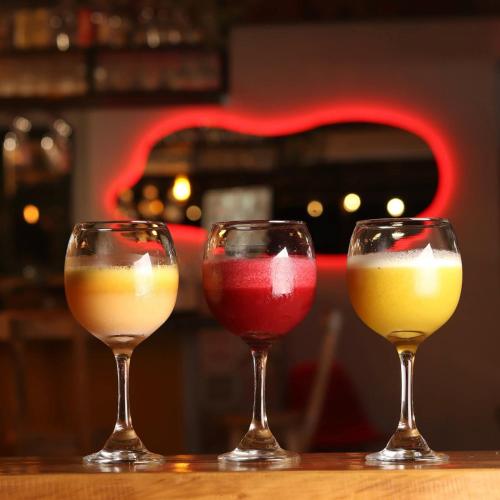 three wine glasses sitting on top of a table at MANIPURA in Guaduas