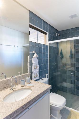 a bathroom with a toilet and a sink and a shower at Chales Maragogi in Maragogi