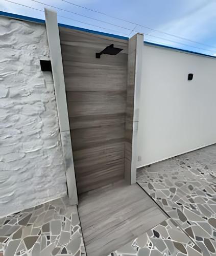 a door in a room with a stone floor at Flats com Temática Grega na Praia de Aruana | Atena Flats in Aracaju