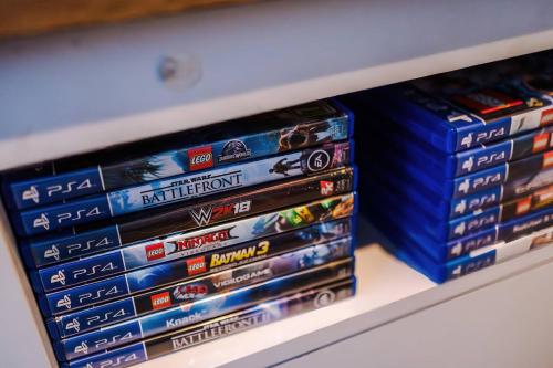 a bunch of dvds are sitting on a shelf at Monthly & Weekly Offers , Pool Table , PS4 , Liverpool , 3 Bed House , Ideal For Contractors , Relocation & Family Stays in Litherland
