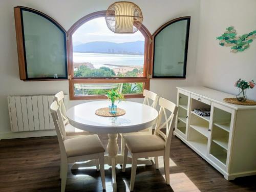 a dining room with a table and chairs and a window at ROYAL BEACH - Appartment with sea view & terrace in Faro de Cullera