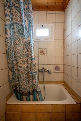 eine Badewanne mit Duschvorhang im Badezimmer in der Unterkunft Hotel Patrai in Lefkada Town