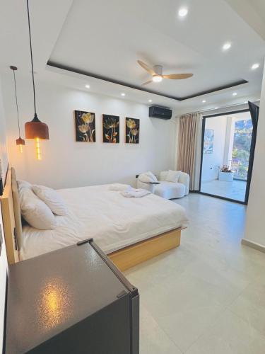 a bedroom with a large bed and a living room at TOKIO - Apartamentos by Luxury Atitlan in San Pedro La Laguna