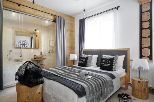 a bedroom with a large bed and a large window at Villa 11 Folk & Design in Zakopane