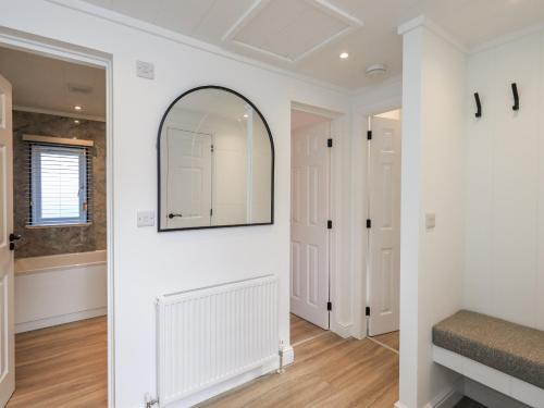 a hallway with a mirror on the wall at Lakeside Lodge in Preston