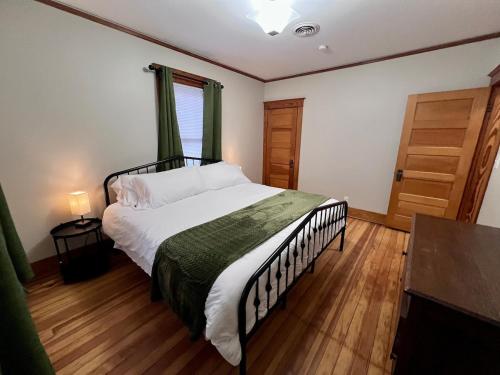 a bedroom with a large bed and a window at Casa Lentini in Omaha