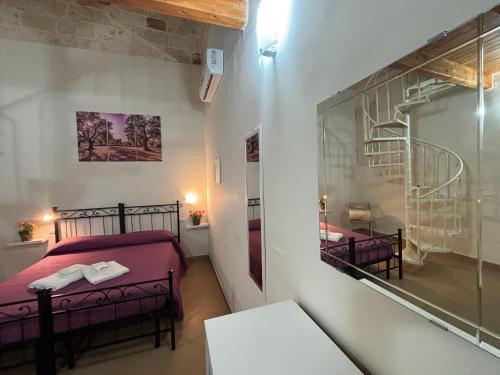 a small room with two beds and a staircase at Casa Vacanze Zia Concetta in Nardò