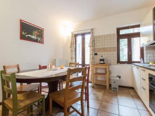 a kitchen and dining room with a table and chairs at Apartment Rote Rose by Interhome in Brusasco