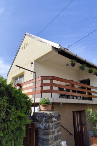 a house with a balcony with plants on it at Apartment Ferienwohnung by Interhome in Tihany