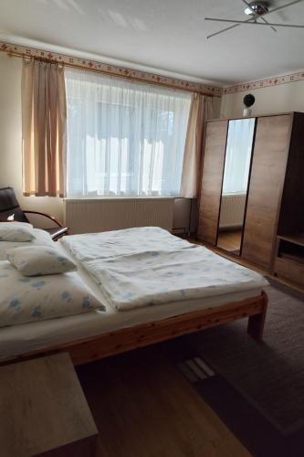 a bedroom with a large bed and a window at Apartment Ferienwohnung by Interhome in Tihany