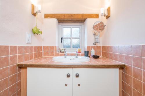 a bathroom with a sink and a window at Y Sied in Newport