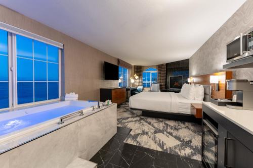 a hotel room with a bed and a tub at Silver Cloud Hotel - Mukilteo Waterfront in Mukilteo