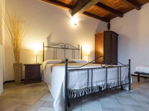 a bedroom with a bed with a wrought iron bed frame at Apartment Girasoli by Interhome in Brusasco