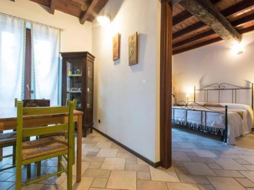 a room with a bed and a table and chairs at Apartment Girasoli by Interhome in Brusasco