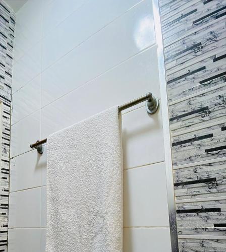 a bathroom with a white towel hanging on a towel rack at Le Cocooning Mermoz-Batrain in Dakar