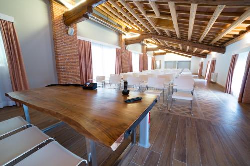 a conference room with a large wooden table and chairs at Fracanzana Hotel in Montebello Vicentino