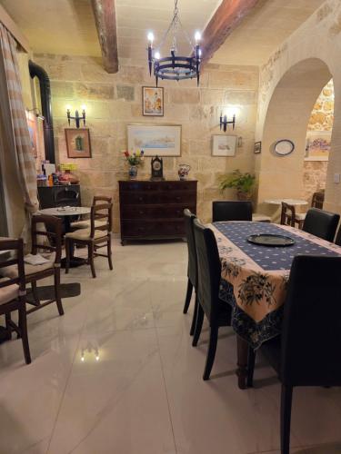 a dining room with a table and chairs at Belvedere Boutique Living Gozo in Żebbuġ