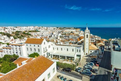 an aerial view of a city with buildings and the ocean at Vila Recife Hotel in Albufeira