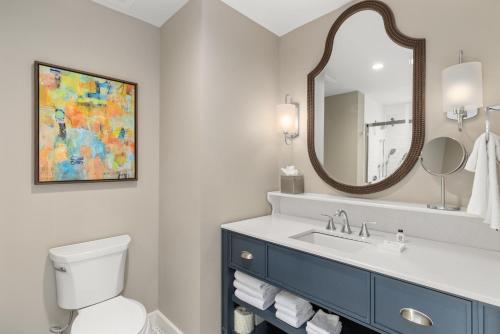 a bathroom with a sink and a mirror at The Shepherd Hotel Downtown Clemson in Clemson