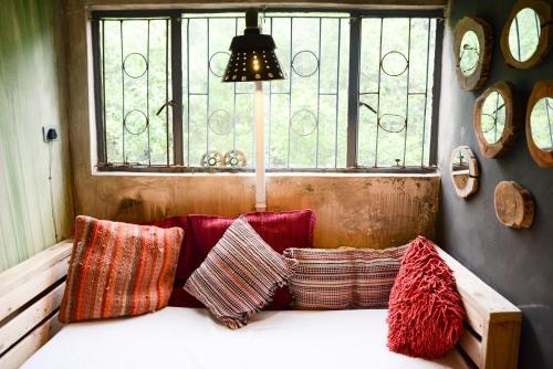 a room with pillows on a bench with a window at The Prawn Hatchery Pty Ltd on Amatikulu in Dokodweni